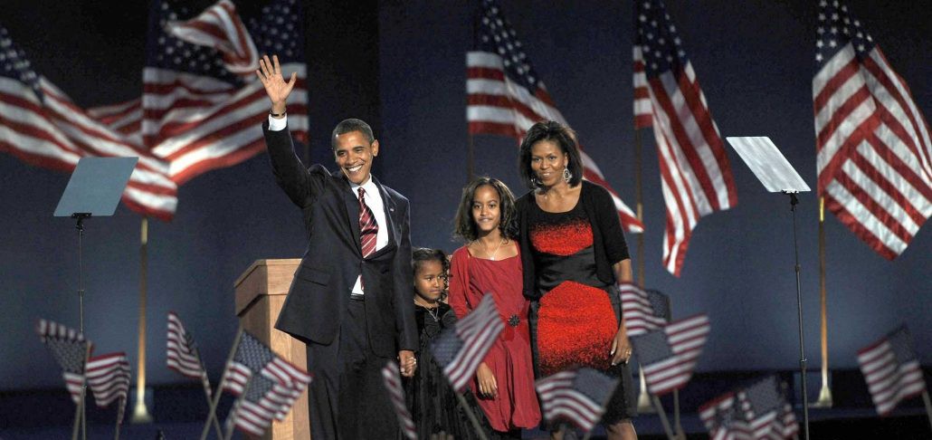 the obama family, victorious on election night, all dressed in black and red